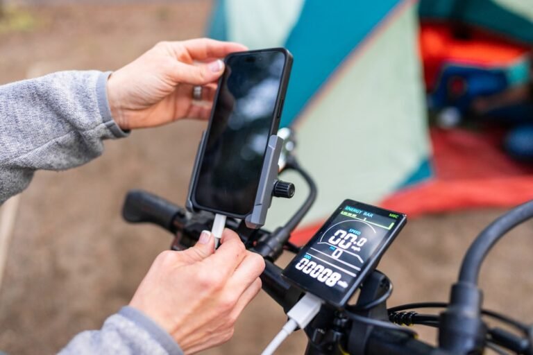 A person on a bike holding a cell phone