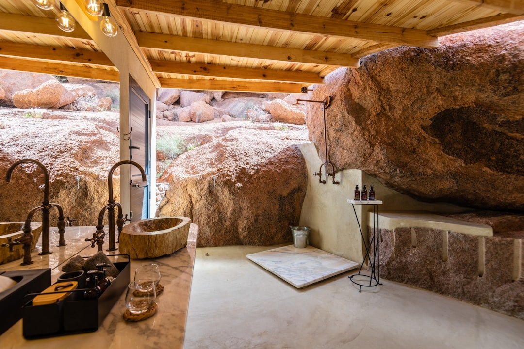 A bathroom with a large rock in the background