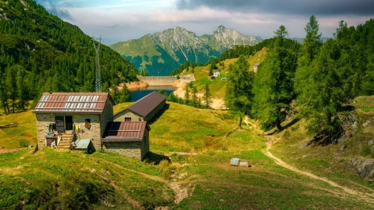 Mountain landscape with buildings and a lake.
