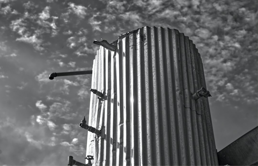 Corrugated metal silo against a cloudy sky