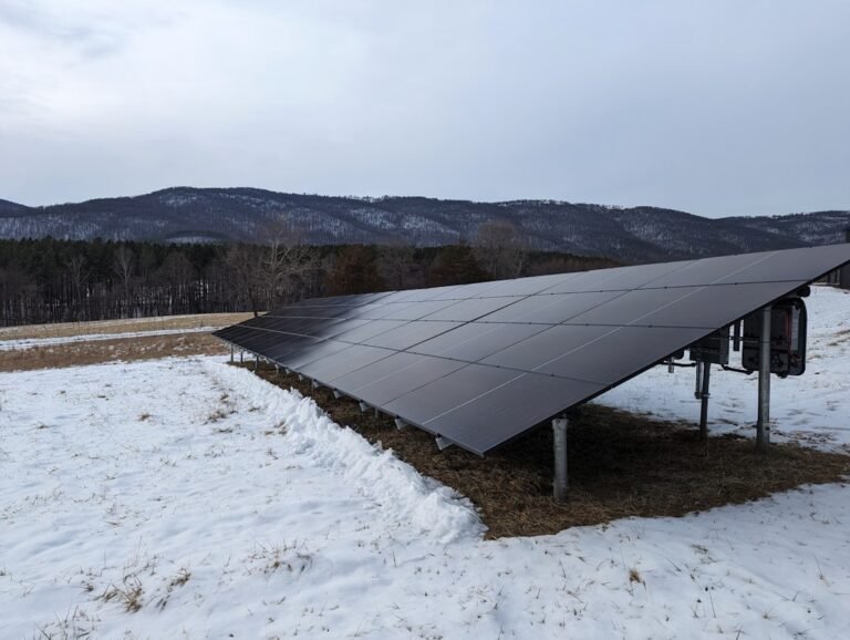 A solar panel in the middle of a snowy field