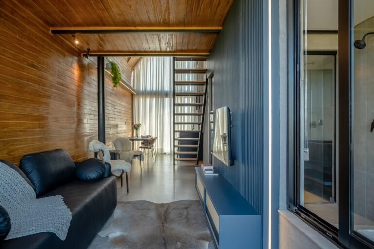 Modern living room with wooden walls and stairs
