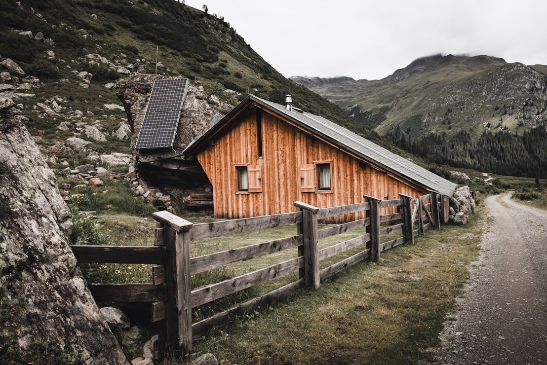 A wooden house with a fence around it