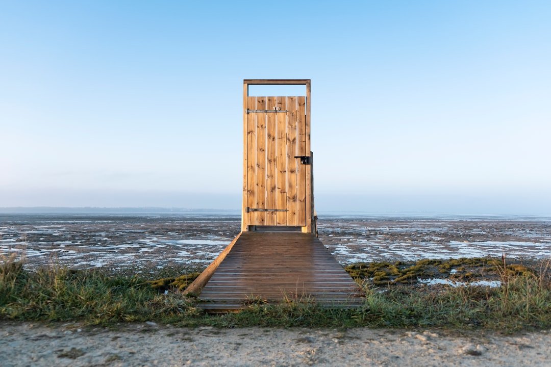 A clock tower next to a body of water