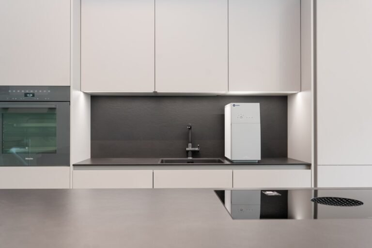 A kitchen with white cabinets