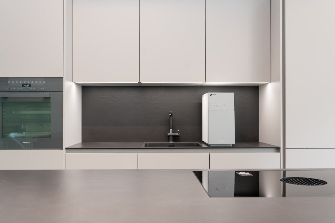 A kitchen with white cabinets