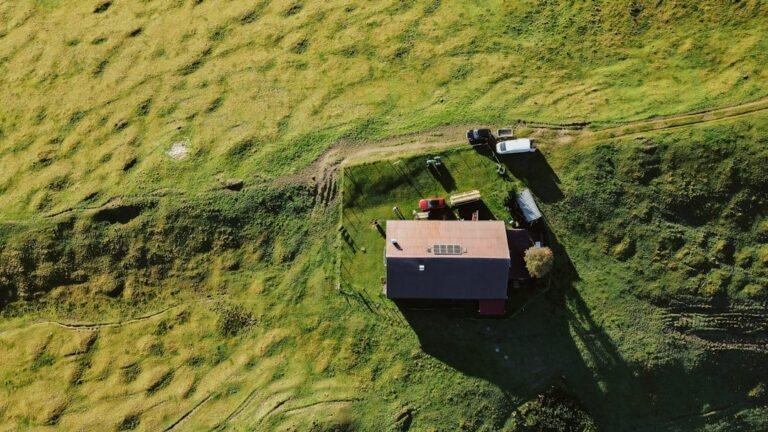 Aerial view of a rural farm with buildings and vehicles.