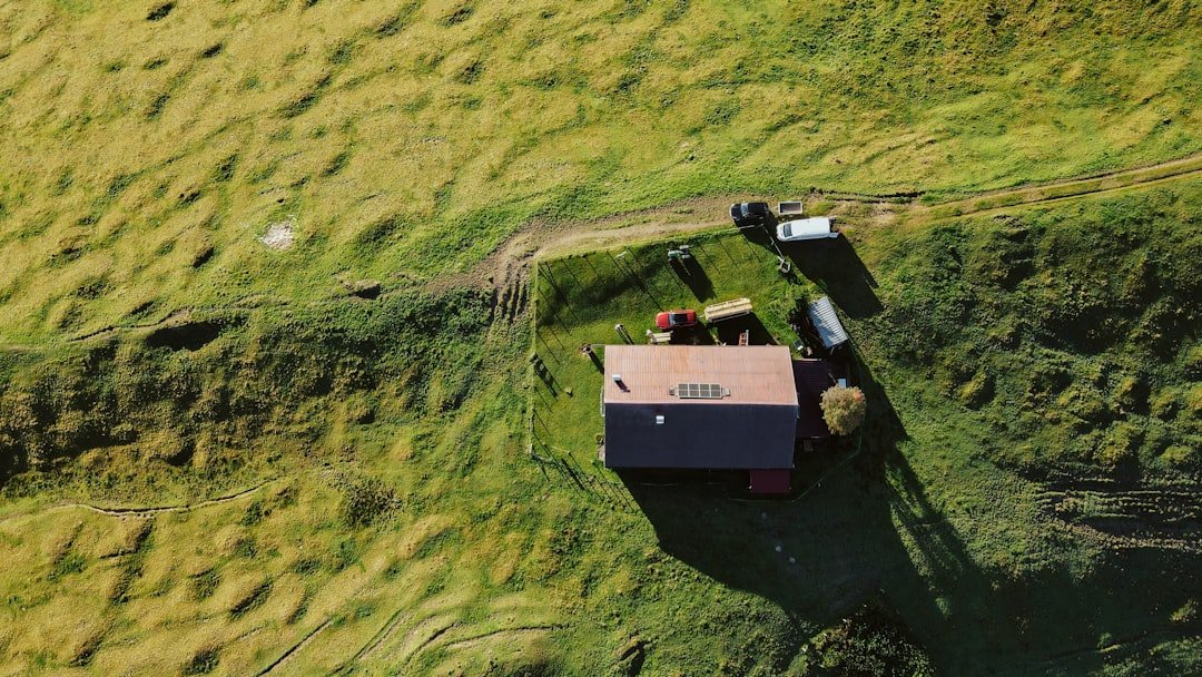 Aerial view of a rural farm with buildings and vehicles.