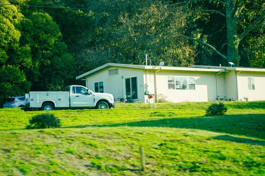 White pickup truck parked in front of a house.