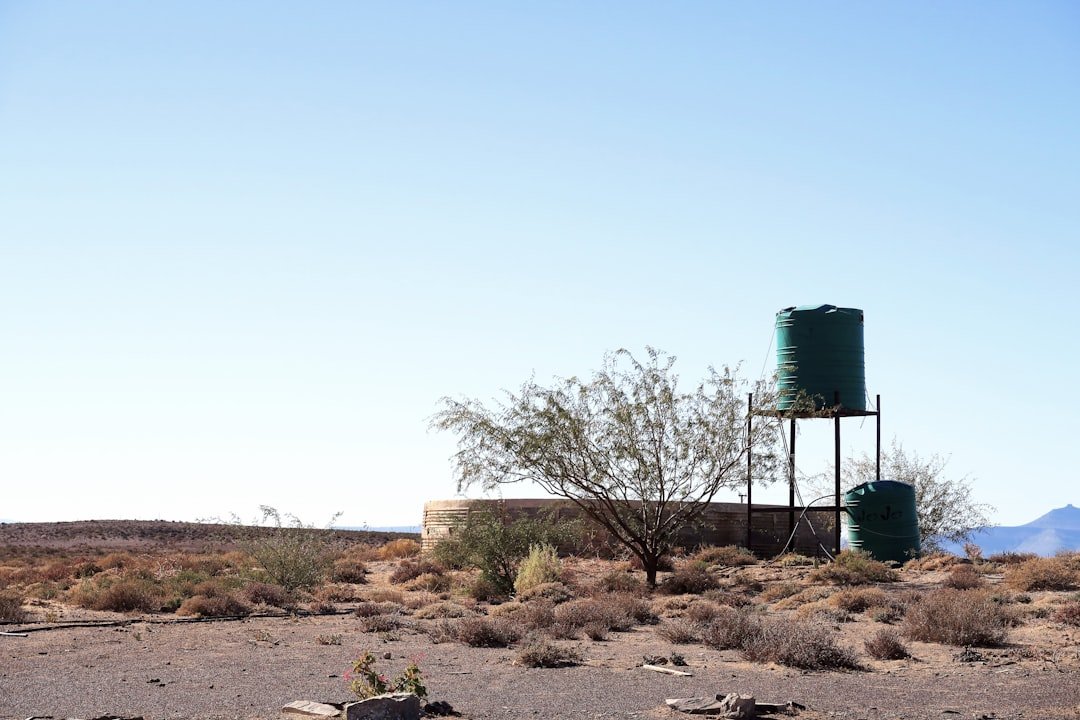 A water tank sitting in the middle of a desert