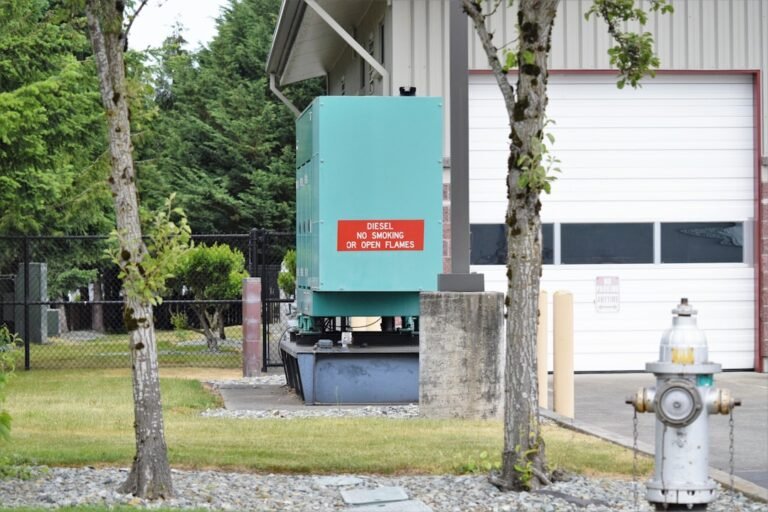 A fire hydrant in front of a building with a sign on it