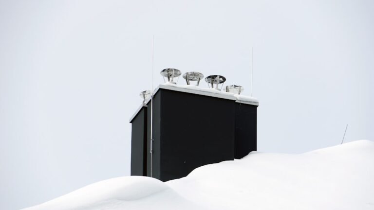 White wooden bed frame with white bed sheet