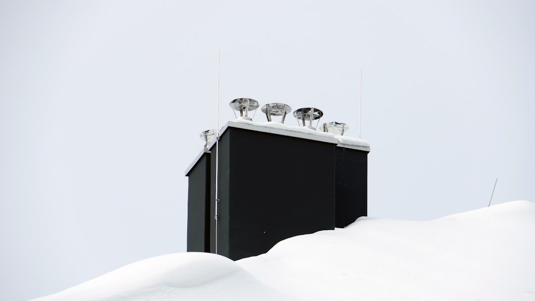 White wooden bed frame with white bed sheet