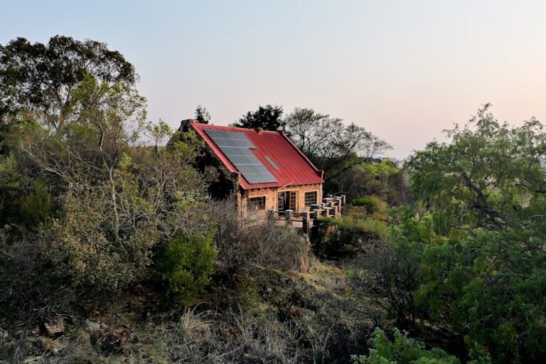 Small house with solar panels on a hill.